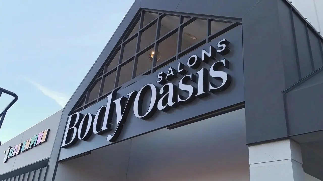 濃い色の外壁に白い大きな文字のサイン。左は Body spa、右は同じ書体の Body Oasis に変わっています (編集後)