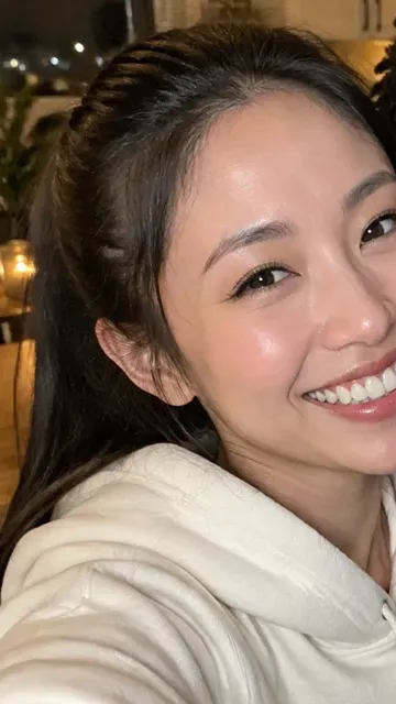 Original photo: smiling woman in a cream hoodie taking a selfie